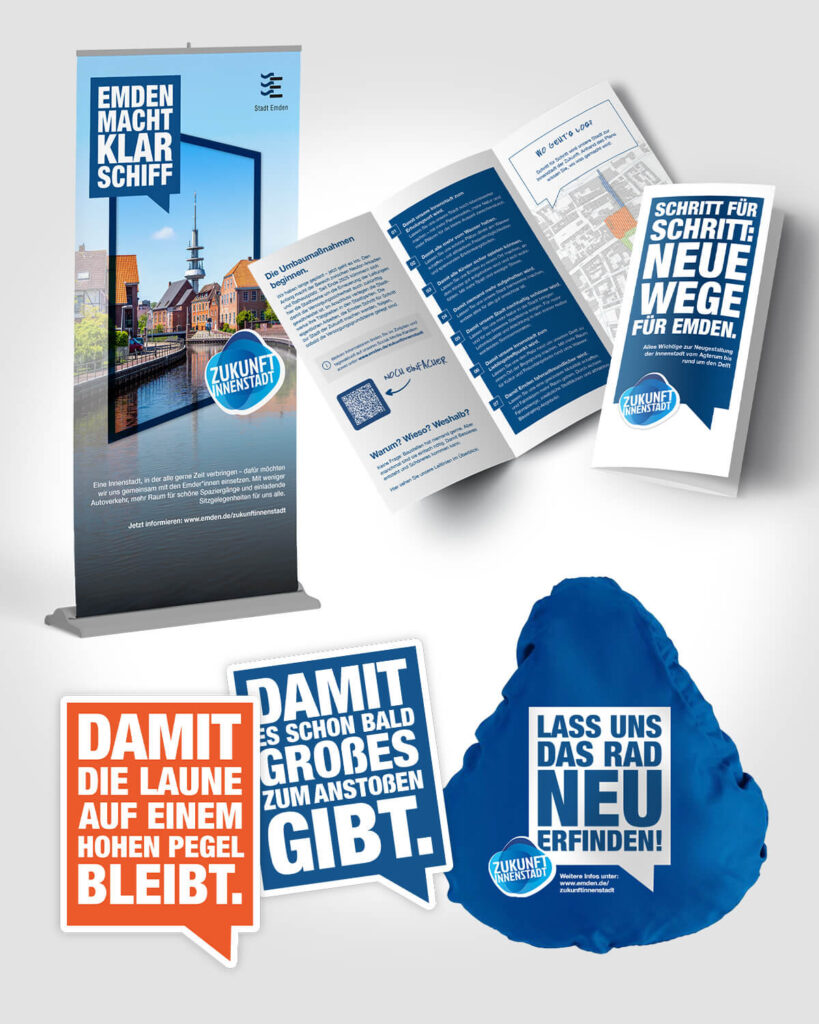 Kommunikationsmittel zur Kampagne mit Roll-up, Flyer, Stickern und Fahrradüberzug